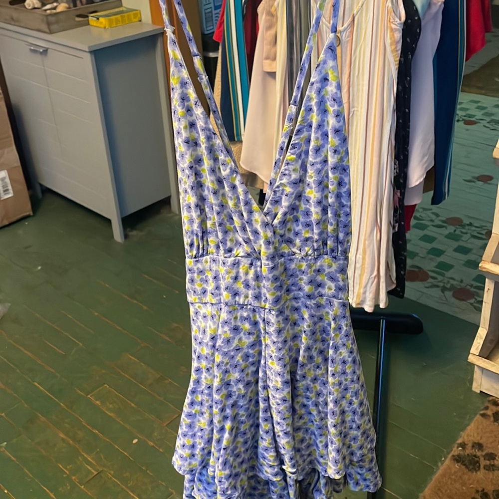 Flower Romper with zipper and bow tie on back.